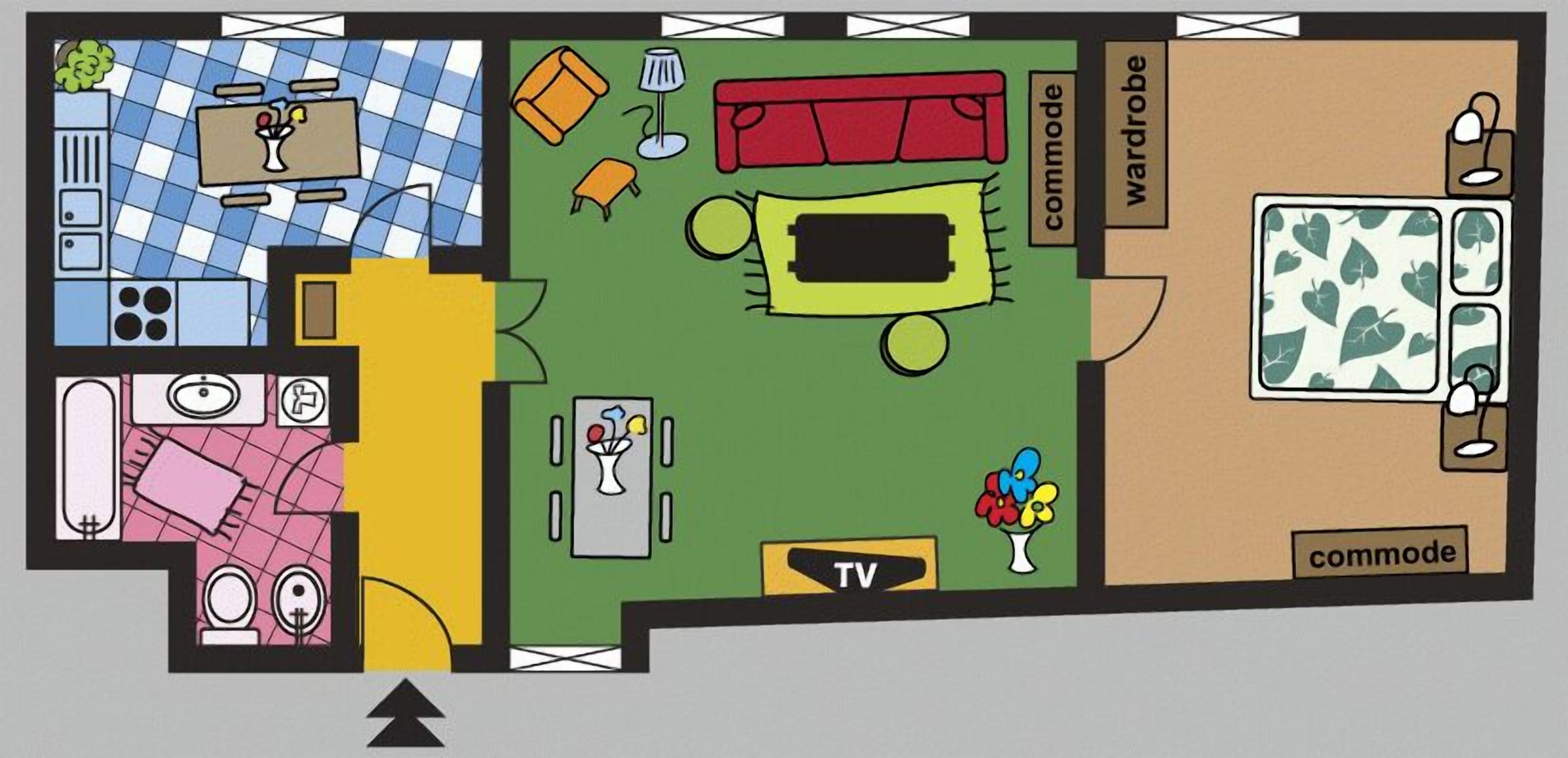 A floor plan with a kitchen, dining area, TV, wardrobe, and a commode.