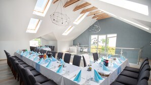 A conference room with a long table set for a meeting, equipped with chairs, tables, and a buffet area. - Villa i Restauracja Tymotka (Lublin)