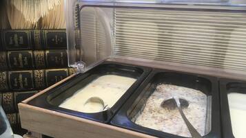 A buffet with multiple serving dishes containing different types of food.