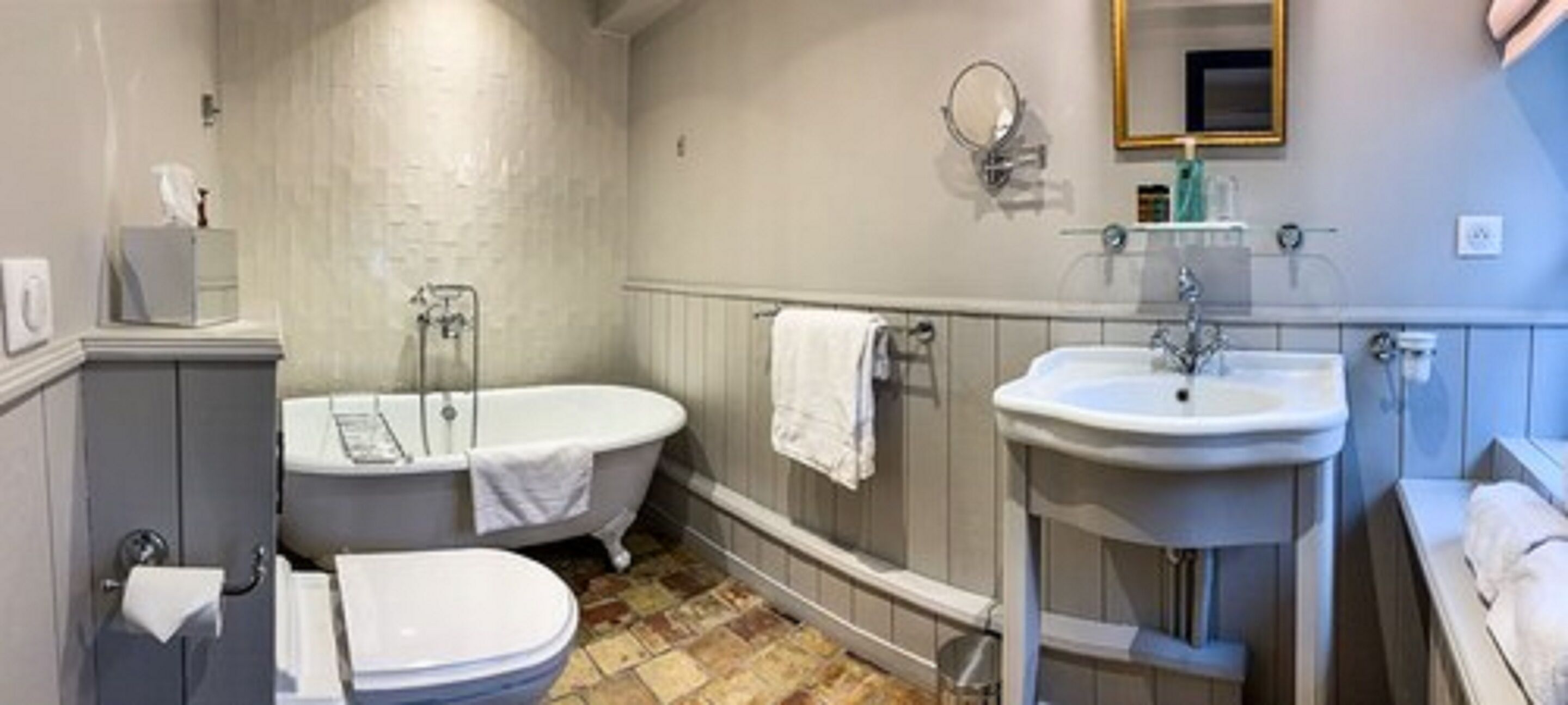 A bathroom with a bathtub, a sink, and a toilet.