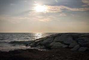 A rocky shoreline with waves crashing against the rocks under a bright sun. - Agriturismo San Matteo (Tarquinia)