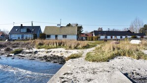 A coastal area with houses, sandy beach, and a concrete path. - 3 bedroom nice home in Borrby (Borrby)
