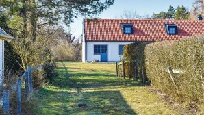 A house with a red-tiled roof, a white exterior, and a blue door. - 3 bedroom nice home in Borrby (Borrby)
