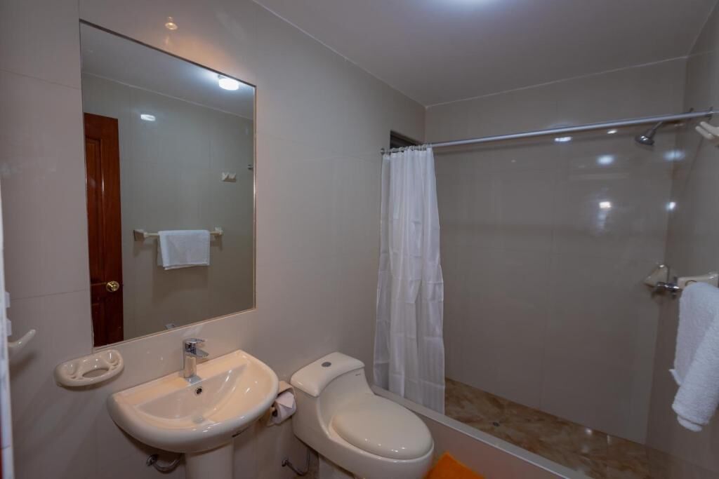 A bathroom with a sink, toilet, and shower.