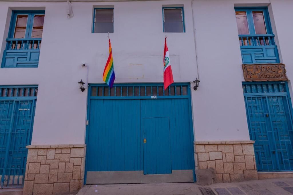 A building with a blue door, two flags, and a sign reading "SPOYS".