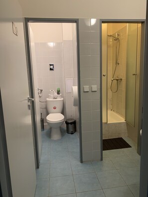 A bathroom with a toilet, bidet, and shower. - Hostel and Apartment Blue88 (Prague)