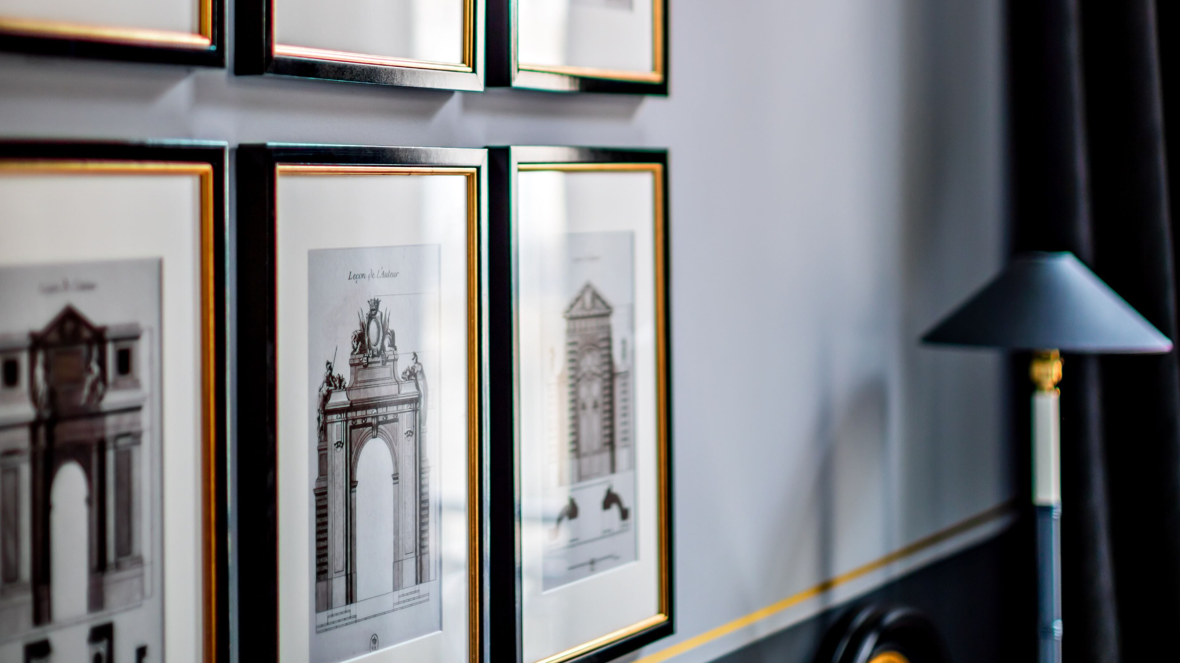 Framed architectural drawings on a wall.