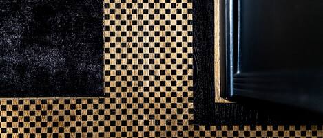A close-up of a checkered floor pattern with a black border and a wooden frame.