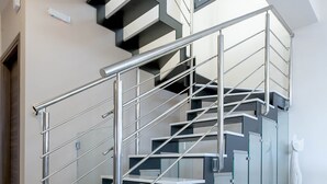 A modern staircase with glass railings and a sleek design. - Marina's Villas (Malevizi)
