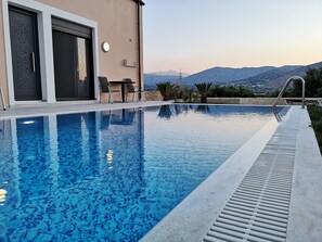 A swimming pool with a view of mountains in the background.