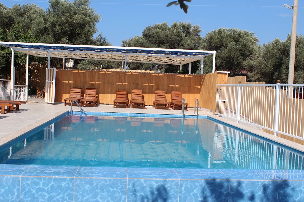 seasonal outdoor pool, pool umbrellas, pool loungers
