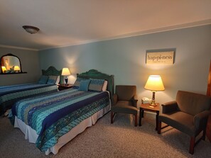 Relax in this inviting room with two single beds, a pair of nightstands, and a comfortable chair.