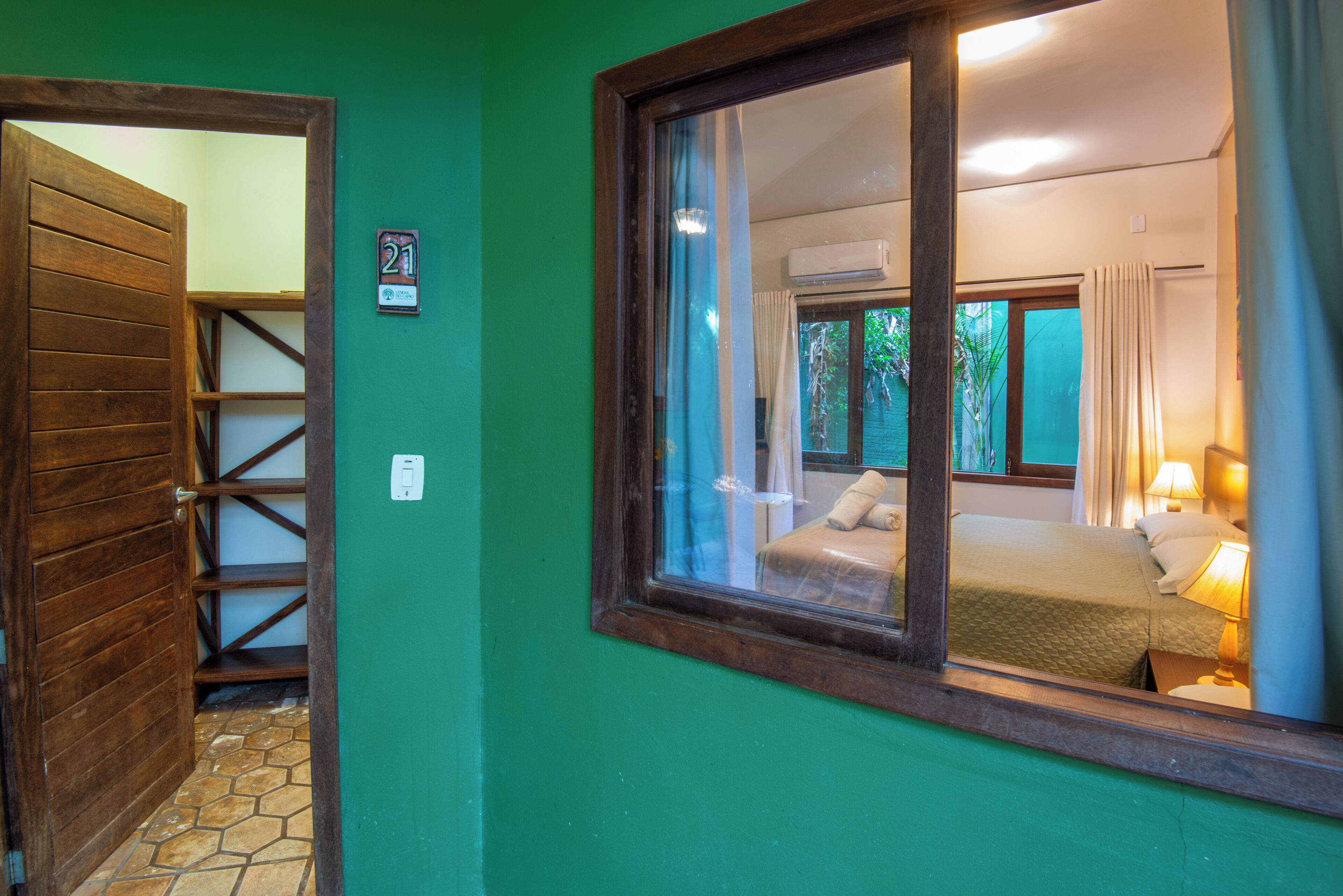 A room with a bed, a window, and a door.