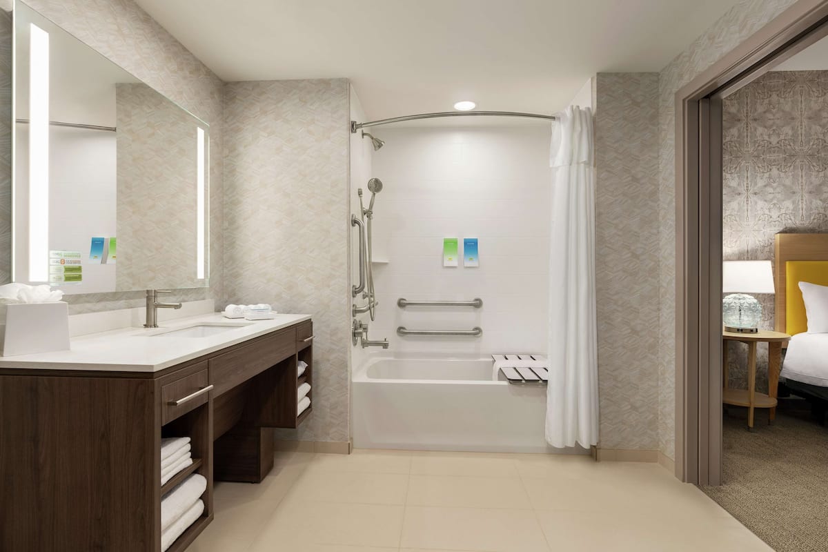 combined shower/bathtub, designer toiletries, hair dryer, towels