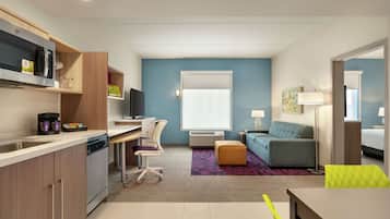 Escritorio, cortinas blackout y tabla de planchar con plancha