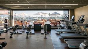A gym with treadmills, benches, and exercise equipment. - DoubleTree by Hilton Celaya (Celaya)