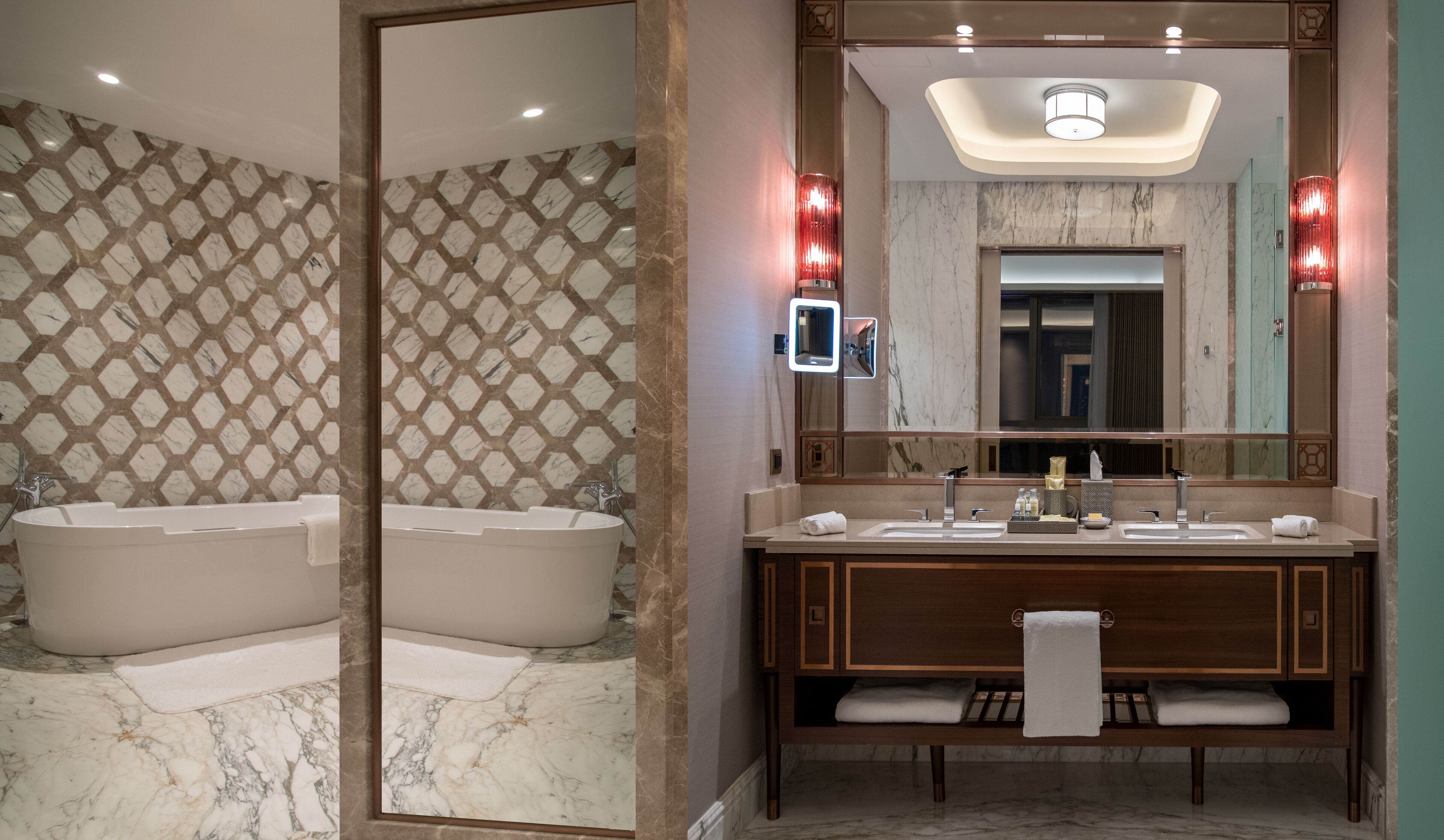 A modern bathroom with a large mirror, two sinks, a bathtub, and a vanity with a towel rack.