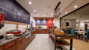A modern kitchen with a chalkboard wall, a waffle station, and a breakfast bar. - Hampton Inn & Suites Duncanville Dallas (Duncanville)