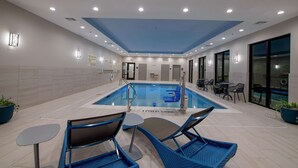 An indoor swimming pool with lounge chairs and tables, a ceiling with recessed lighting, and a no diving sign. - Hampton Inn & Suites Duncanville Dallas (Duncanville)