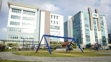 Explore a vibrant urban park with a playground area and modern architecture.