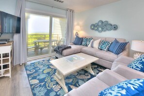 Living area - Oceanfront OIBV 1001 in Caswell Beach, a spacious 3-bedroom condo ideal for 8. (Caswell Beach)