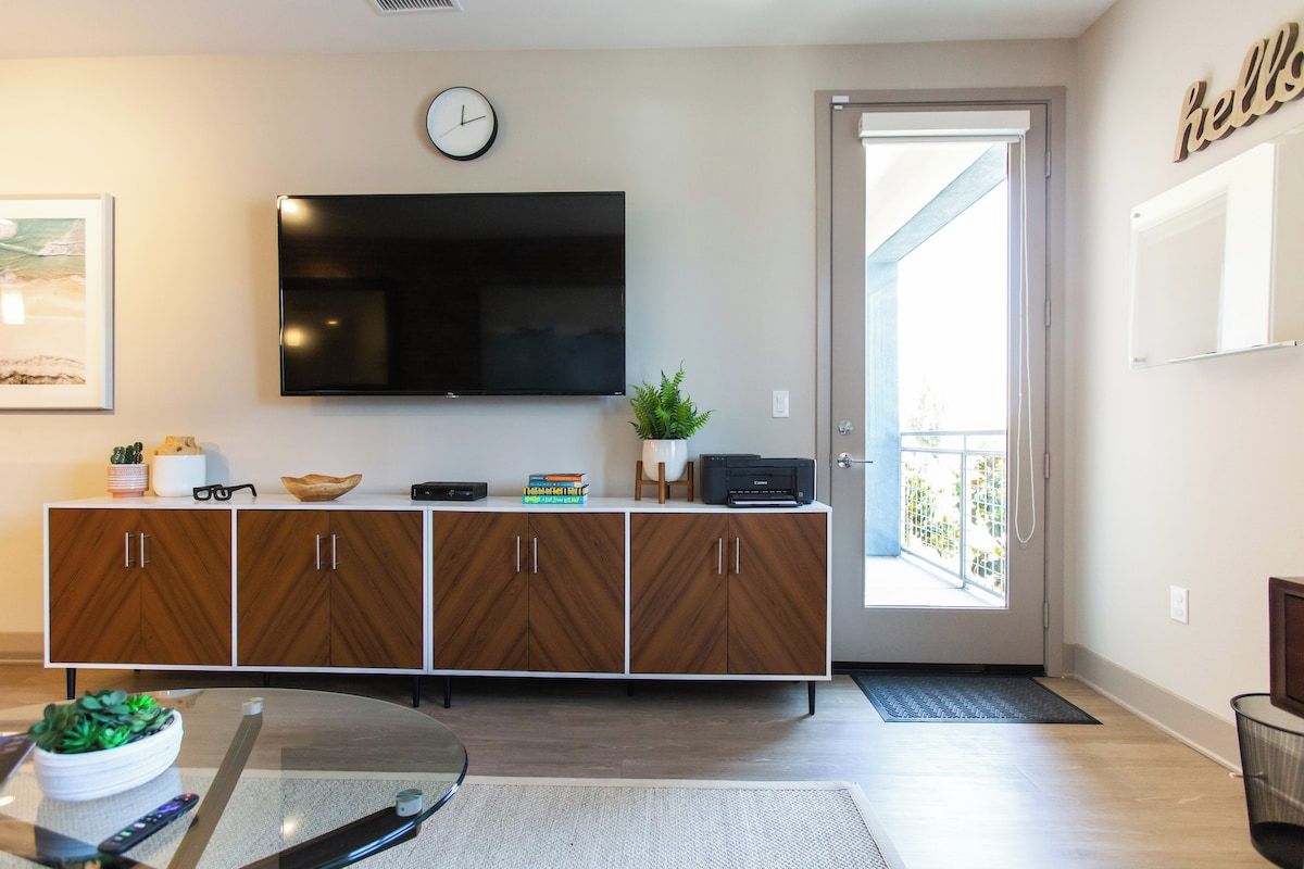 Living room with a smart TV and balcony access