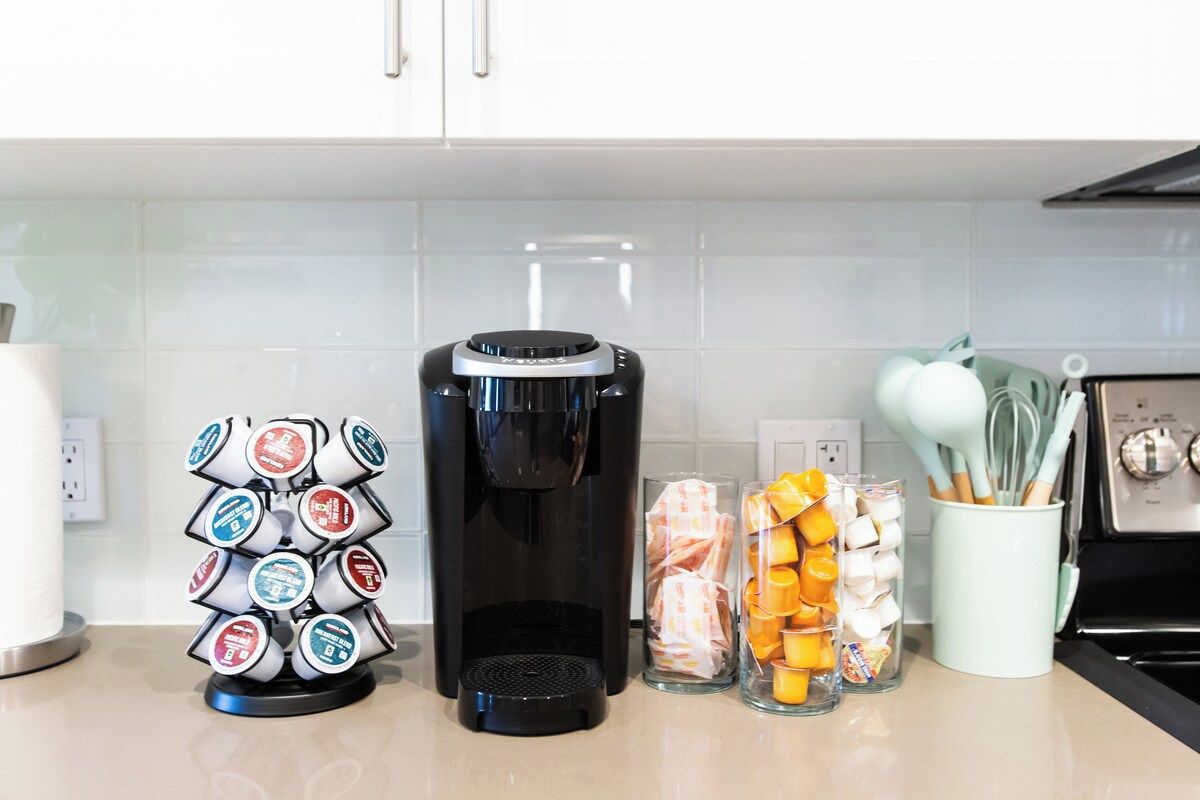 Coffee station with a Keurig machine and pods plus sugar and creamer