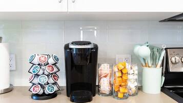 Coffee station with a Keurig machine and pods plus sugar and creamer
