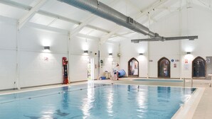 An indoor swimming pool with clear lanes, safety equipment, and signage indicating pool depth. - The Bay - The Bolthole (Filey, near Scarborough)