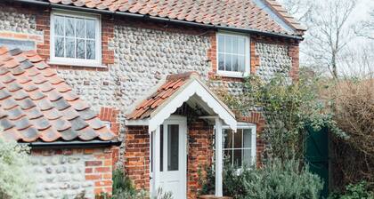 Charming detached flint cottage on village green, 5 minute stroll to beach