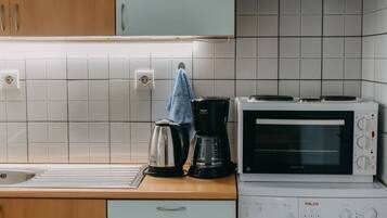 Een koelkast, een oven, een kookplaat, een koffiezetapparaat/waterkoker