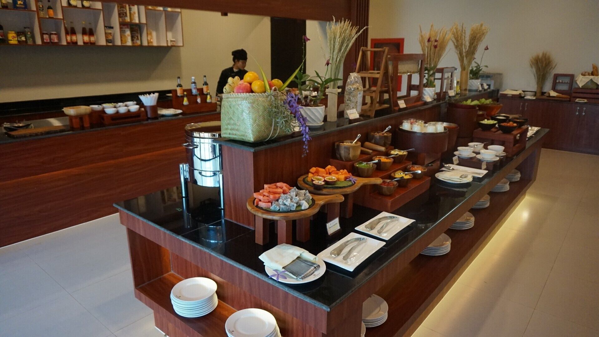 A buffet setup with various food items and condiments.