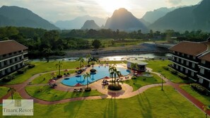 A resort with a large pool, multiple buildings, and a river. - Tmark Resort Vang Vieng (Vang Vieng)