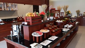 A buffet setup with various food items and utensils. - Tmark Resort Vang Vieng (Vang Vieng)