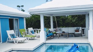 A pool area with lounge chairs and a covered seating area. - Waterside Paradise! (Thompson Cove)