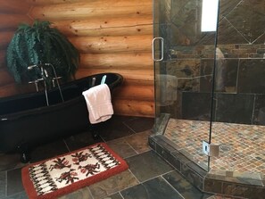 Bathtub, hair dryer, towels, toilet paper