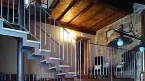 A multi-level interior with a staircase, stone walls, and a wooden ceiling. - Full rental house for 8-10 people, ideal for families with pets. (Ponte-Caldelas)