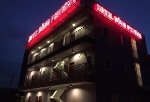 A multi-story hotel with balconies and a prominent red sign. - Khach San Dong Phuong (Ho Chi Minh City)
