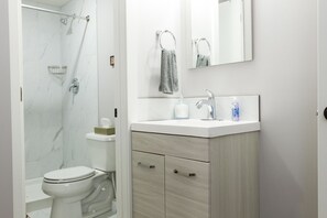 Combined shower/bathtub, hair dryer, towels, soap