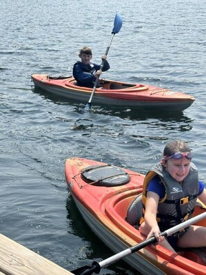 Two kayaks on calm water.