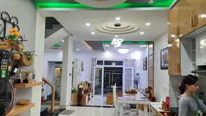 A modern interior with a dining area, kitchen, and a hallway leading to another room.