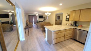 Relax in a spacious living area with a comfortable seating area, fireplace, and dining table.