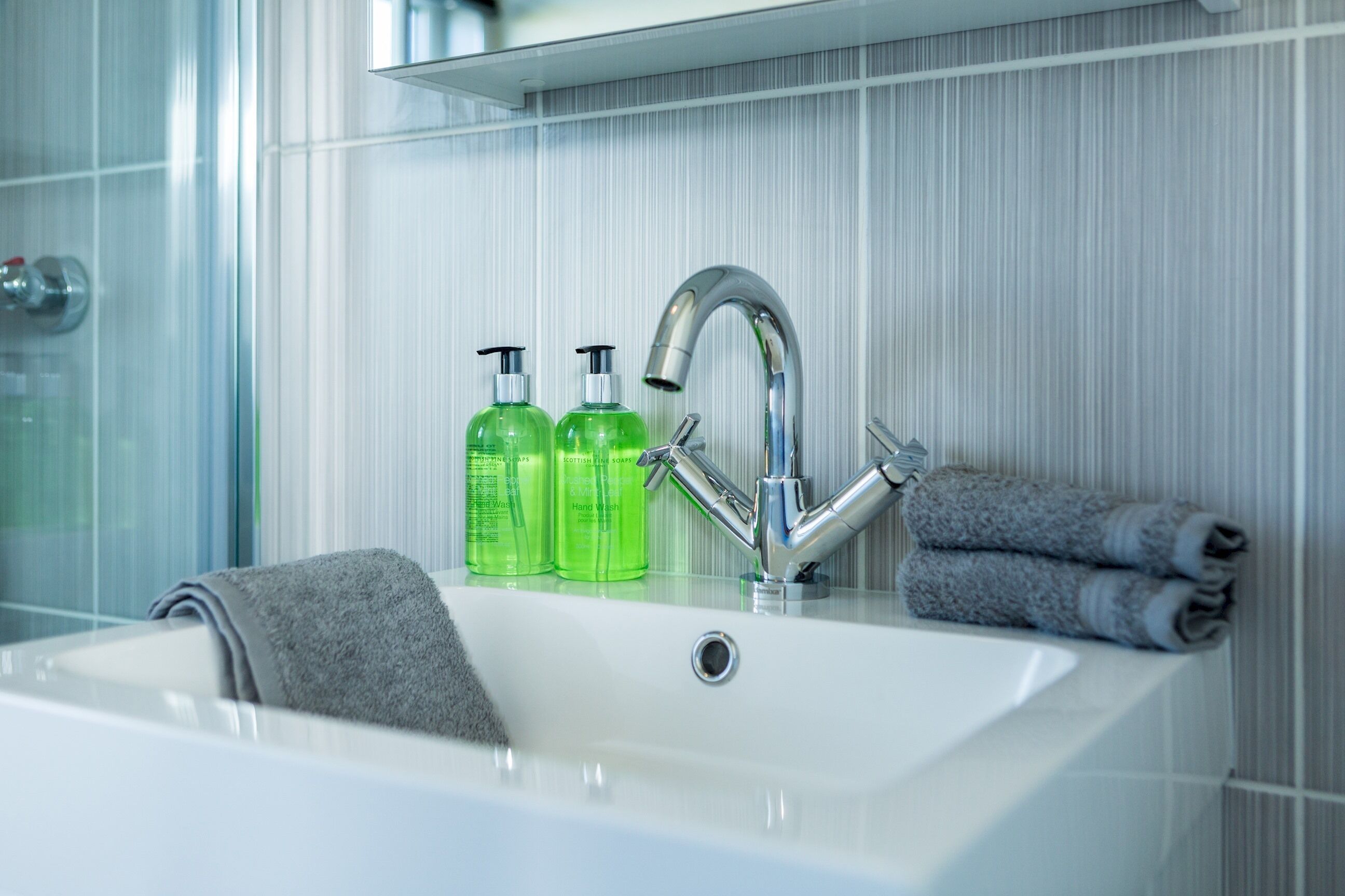 Combined shower/bathtub, towels, toilet paper