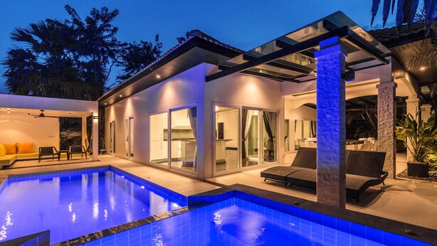 A modern house with a swimming pool, outdoor seating, and a covered patio area. - Perfect holiday home (Hua Hin)