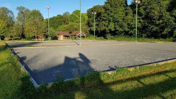 An empty parking lot with a building in the background.