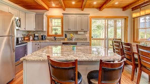 A kitchen with granite countertops, wooden chairs, and a large island. - Manchester,  Mt Equinox Views, Hot Tub, Horse-show,golf,skiing,hiking,fishing (Sunderland)