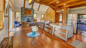 A spacious kitchen with wooden beams, a stone fireplace, and modern appliances. - Manchester,  Mt Equinox Views, Hot Tub, Horse-show,golf,skiing,hiking,fishing (Sunderland)
