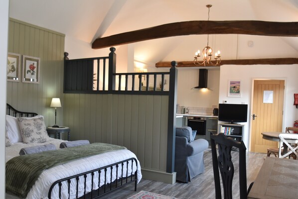 A bedroom with a bed, a desk, a chair, and a television. - Daisy Cottage, Sleeps 2 - Romantic Retreat in Rye, East Sussex, UK (Rye)