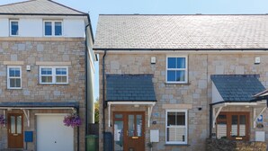 A row of stone houses with front doors, windows, and a small garden area with potted plants. - Honeysuckle Cottage, Lelant – Sleeps - On-Site Parking – Dog Friendly (Lelant)