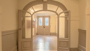 A hallway with a double door and a decorative archway.